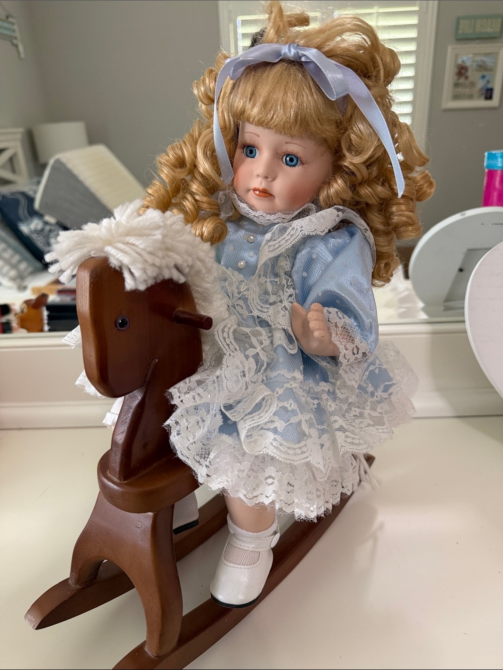 Blue Lace Dress Porcelain Doll on Wooden Rocking Horse